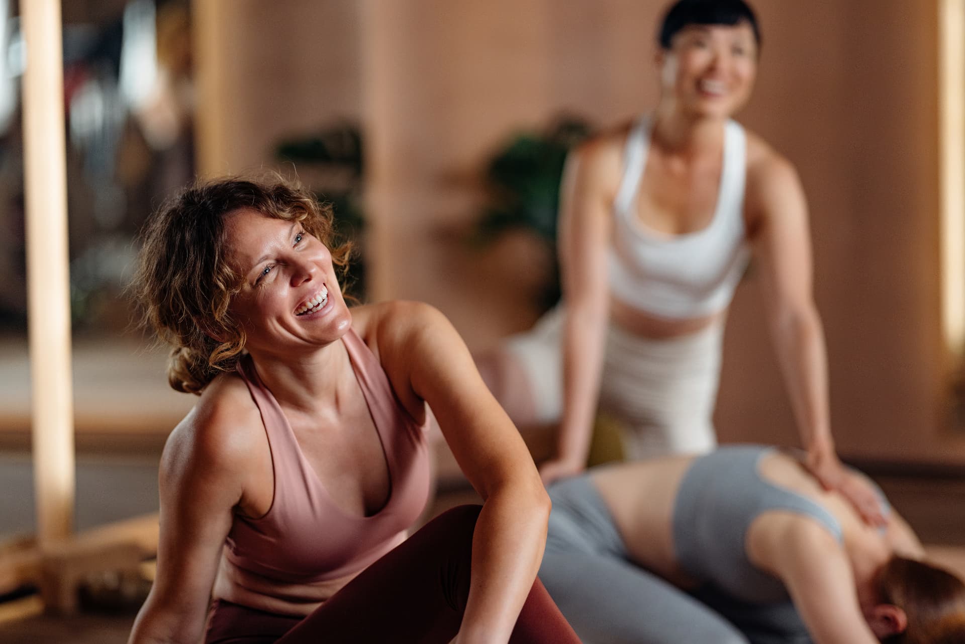 Women smiling together during a wellness and movement class.